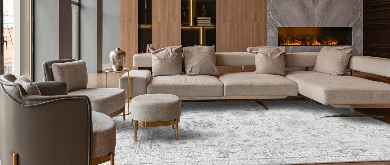 Modern liviing room with low pile muted blue traditonal floral rug